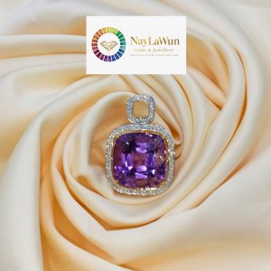 A large emerald and diamond pendant