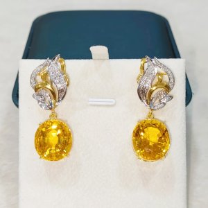 A beautiful, graceful beauty with a beautiful emerald and diamond earring.