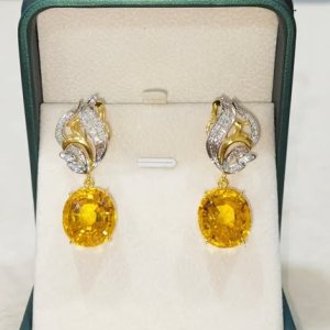 A beautiful, graceful beauty with a beautiful emerald and diamond earring.