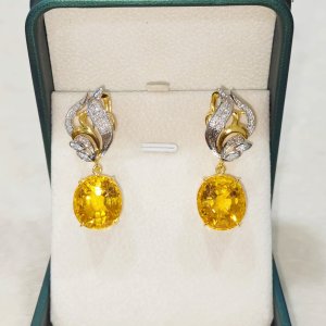 A beautiful, graceful beauty with a beautiful emerald and diamond earring.