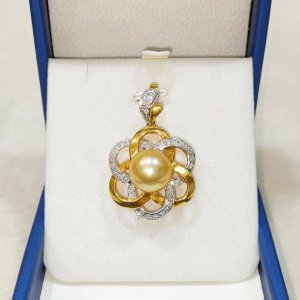 A beautiful pearl, gold, and diamond pendant that will capture your heart.